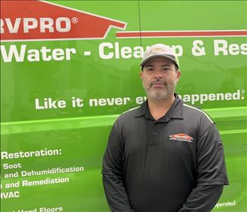 A man in front of a SERVPRO truck.