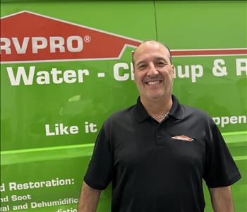 A MAN IN FRONT OF A SERVPRO TRUCK.