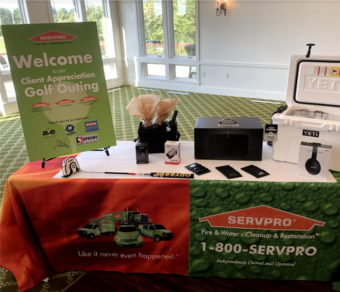 a booth with a black tablecloth and SERVPRO logo